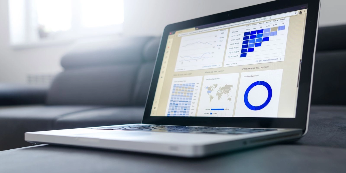 A laptop screen showing a data analytics dashboard with charts