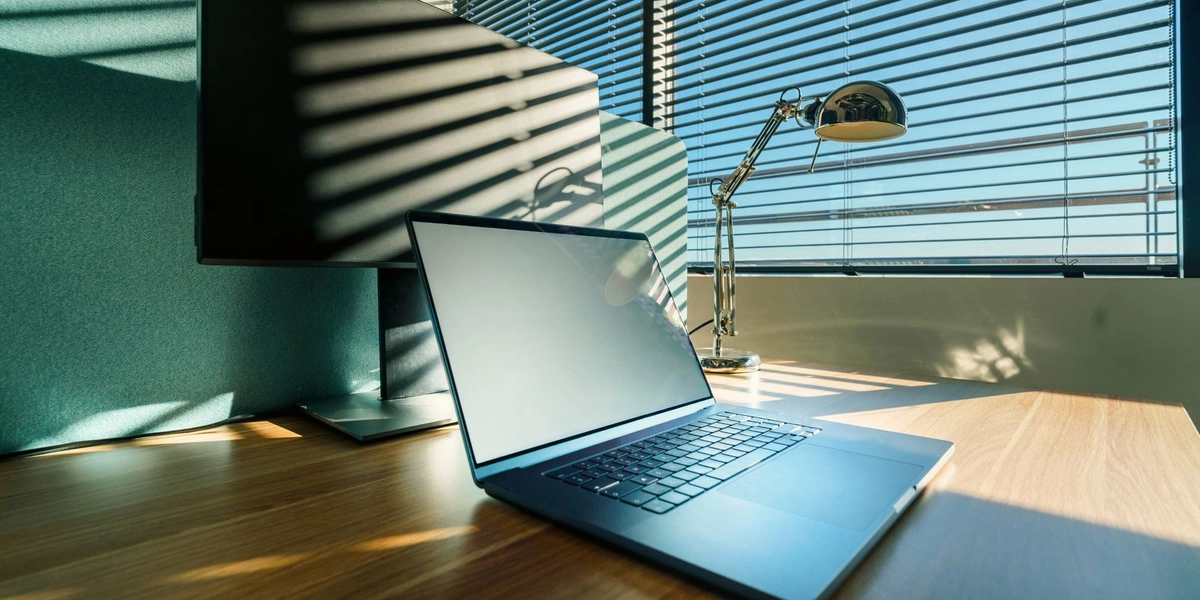 A modern, sunlit office desk with a laptop, representing RFP templates and tools