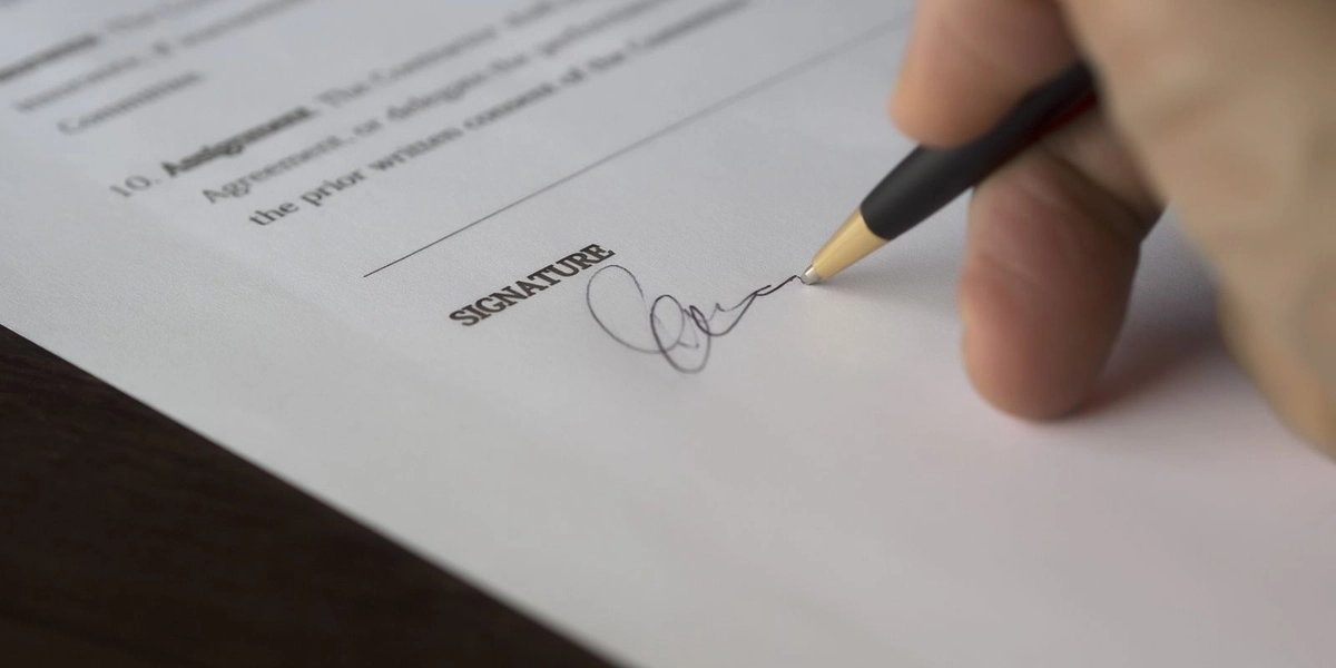 Signing a contract document, representing the final stage of the RFP process